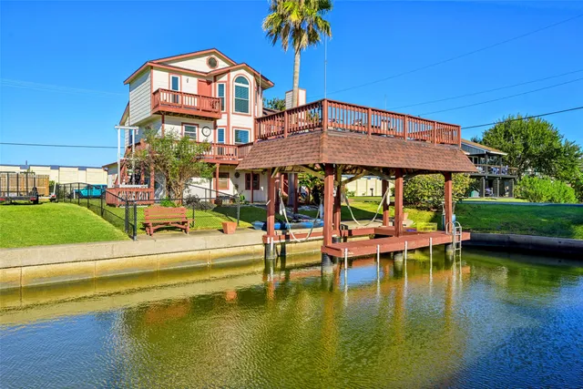 a view of a swimming pool with a table and chairs under an umbrella