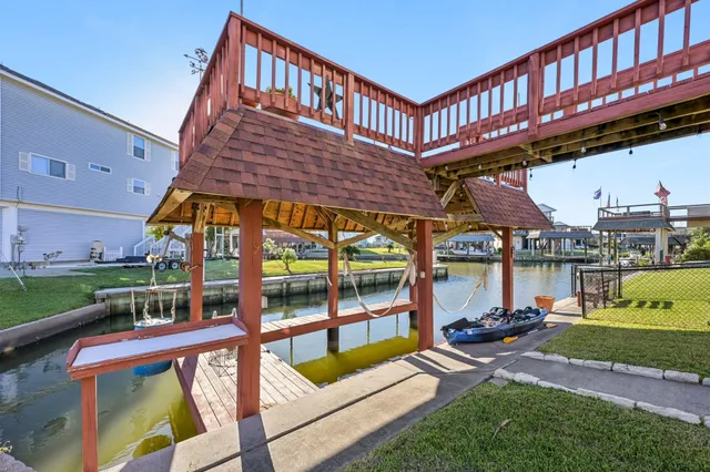 a view of a swimming pool with a patio and a yard