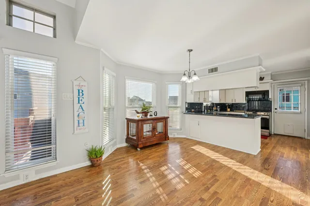 a kitchen with kitchen island granite countertop lots of counter top space and stainless steel appliances