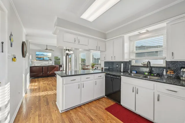 a kitchen with granite countertop a sink and cabinets