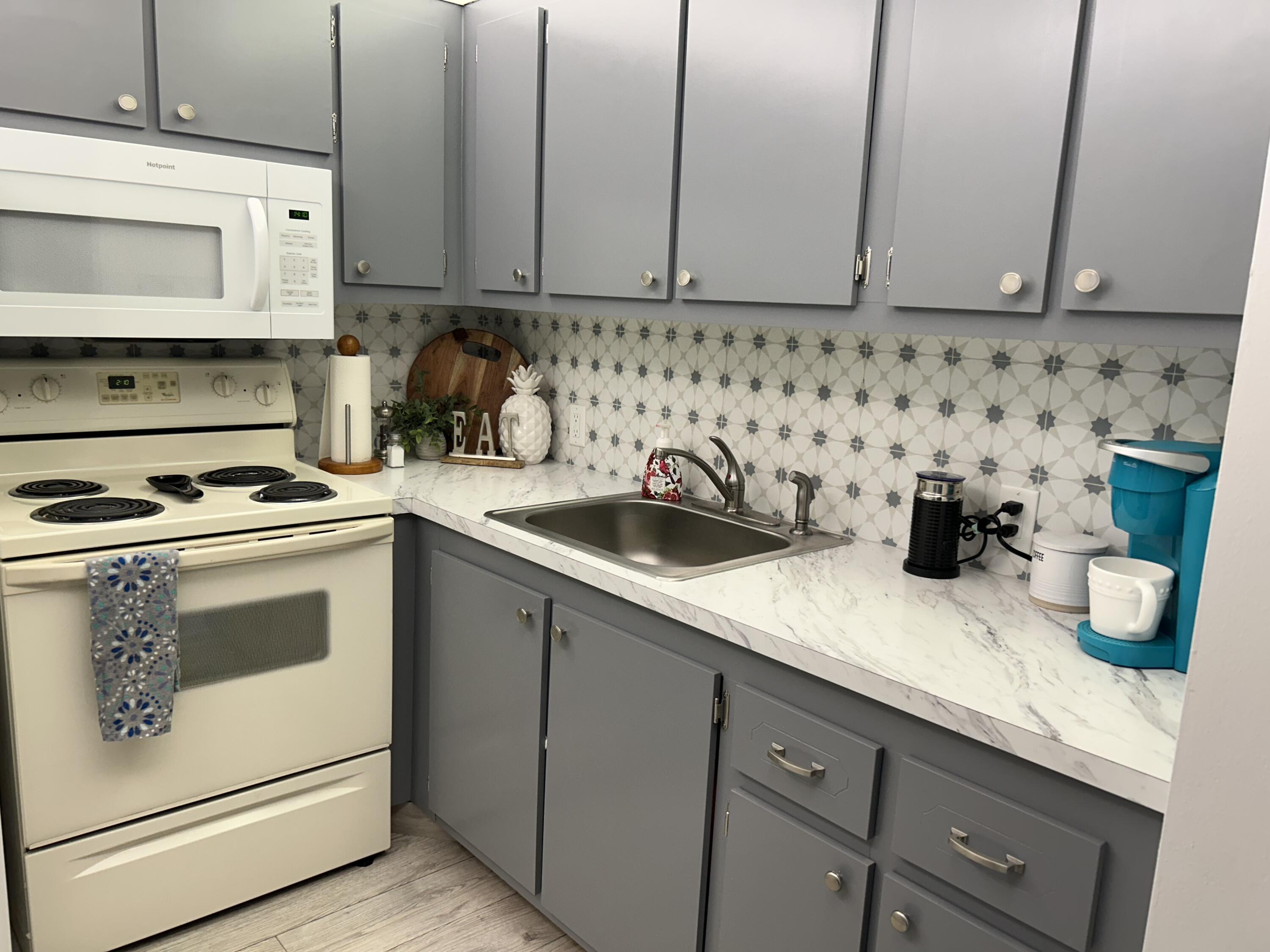 a kitchen with appliances cabinets and a sink