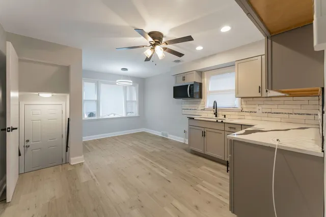 a kitchen with a stove a sink and a refrigerator