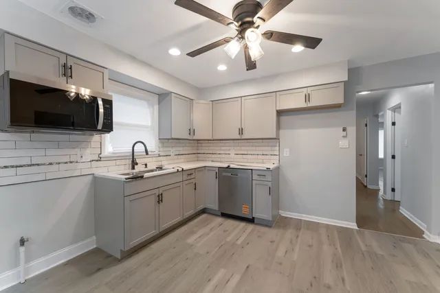 a kitchen with a sink stainless steel appliances and cabinets