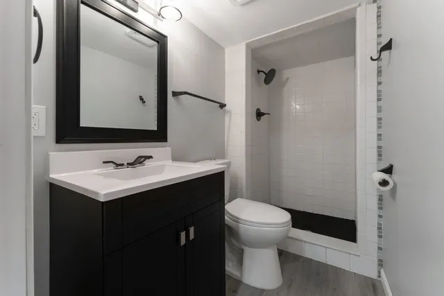 a bathroom with a sink toilet and shower
