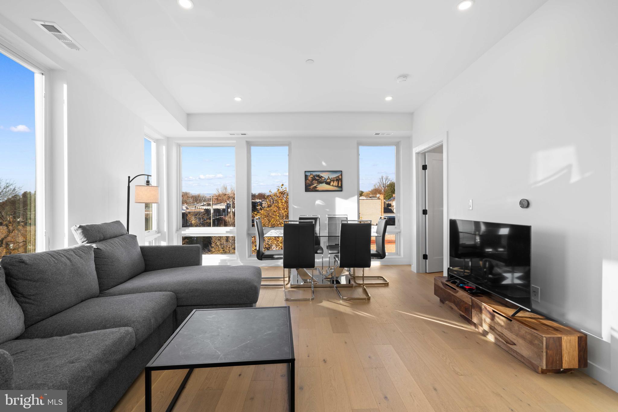 30 Kennedy Street Northwest, Unit 14 Washington, DC 20011 - Photo 14 of 40 a living room with furniture a flat screen tv and a window