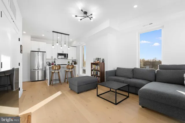 a living room with furniture kitchen and a fireplace