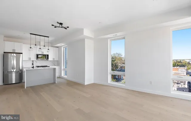 a kitchen with stainless steel appliances a refrigerator and a window