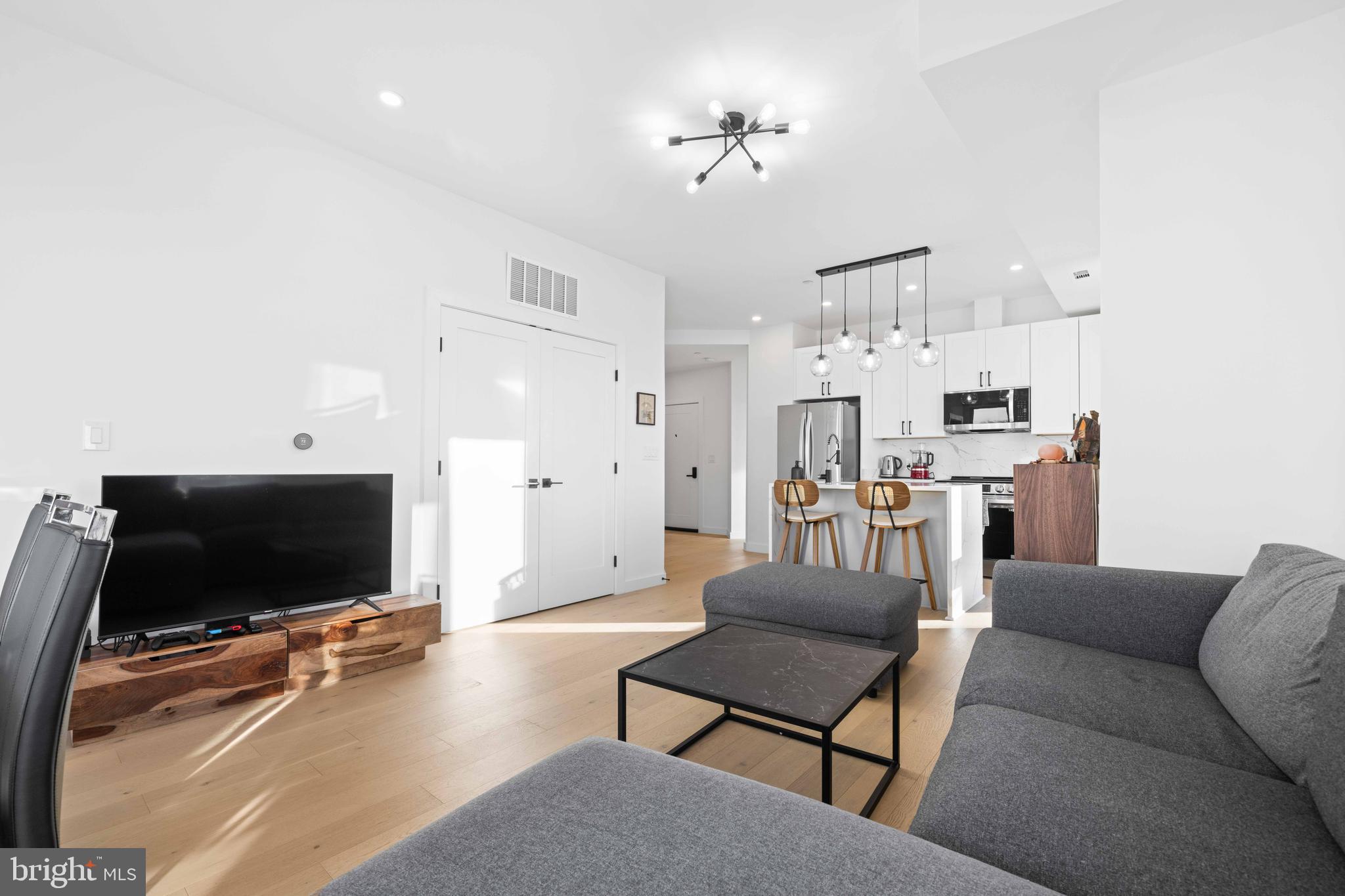 30 Kennedy Street Northwest, Unit 14 Washington, DC 20011 - Photo 19 of 40 a living room with furniture and a flat screen tv
