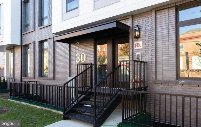 a view of a house with a wooden floor and a large window