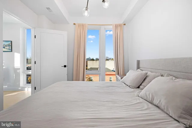 a bedroom with a large bed and a large mirror