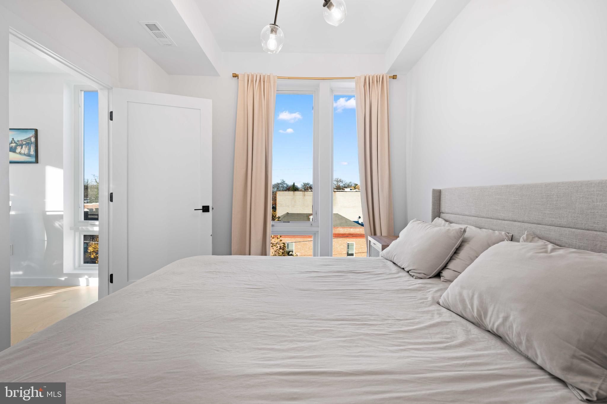 30 Kennedy Street Northwest, Unit 14 Washington, DC 20011 - Photo 23 of 40 a bedroom with a large bed and a large mirror