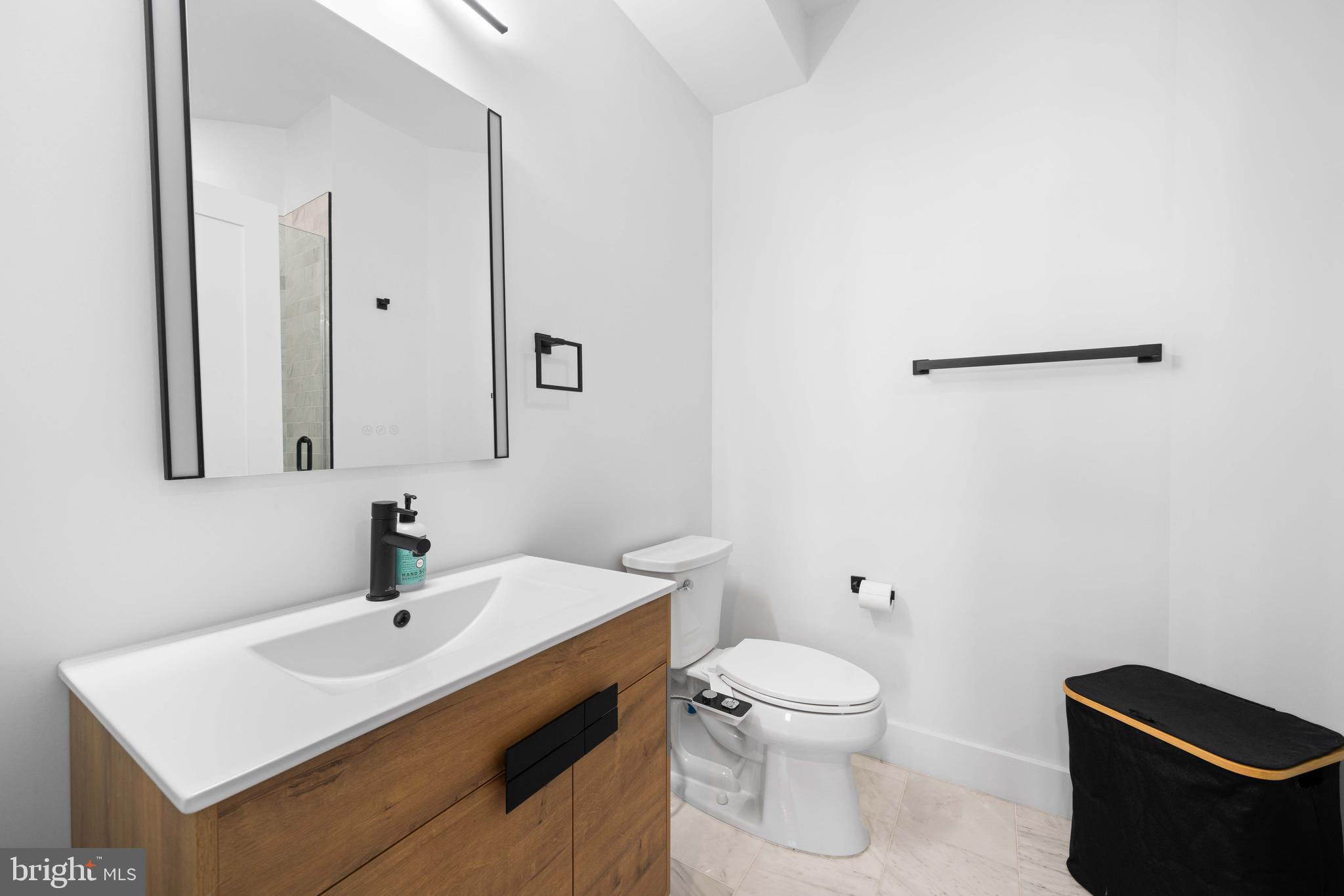30 Kennedy Street Northwest, Unit 14 Washington, DC 20011 - Photo 27 of 40 a bathroom with a toilet sink and mirror