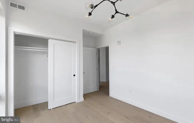 a view of a room with rack and chandelier