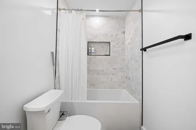 a bathroom with a shower a toilet and a sink