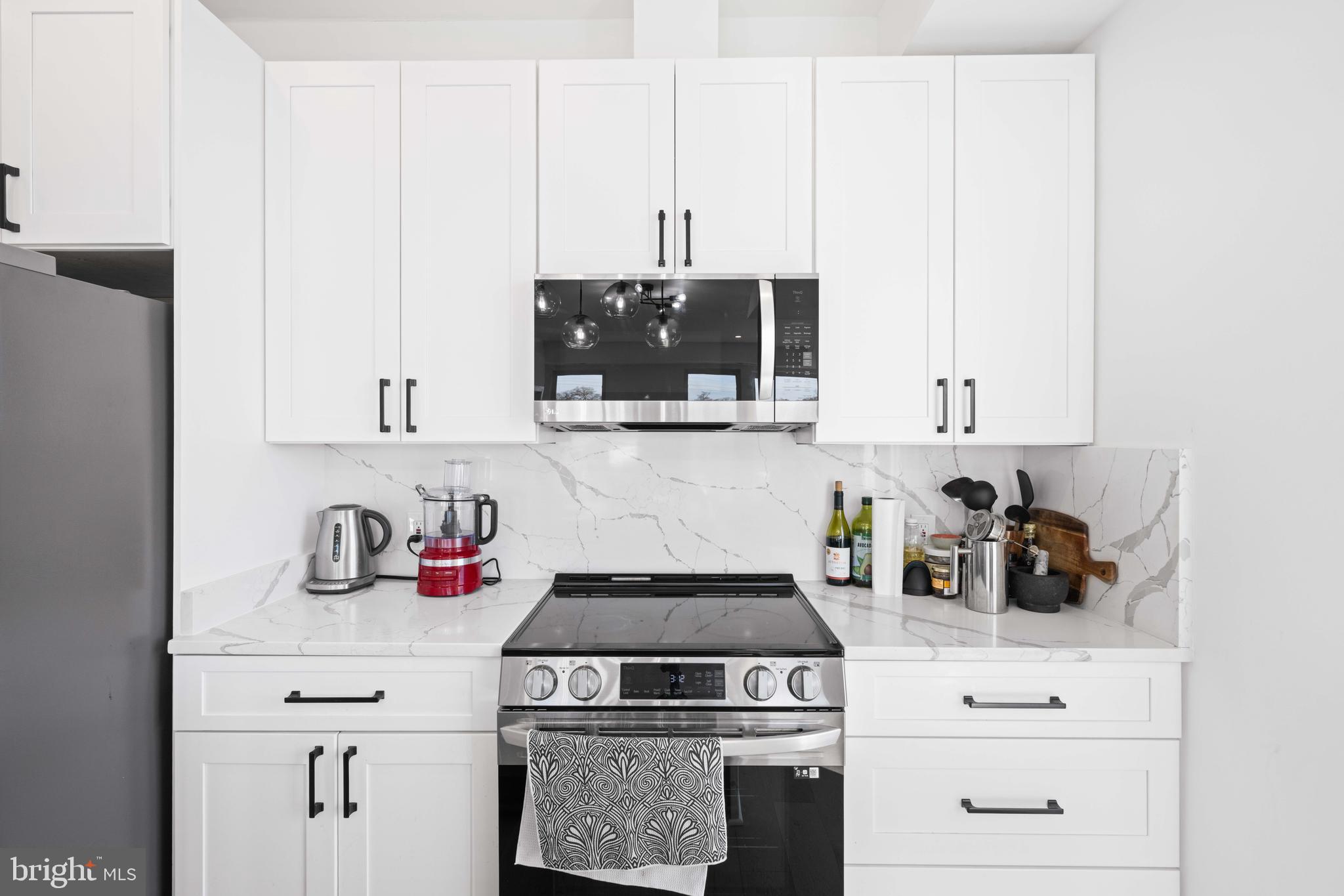 30 Kennedy Street Northwest, Unit 14 Washington, DC 20011 - Photo 7 of 40 a kitchen with white cabinets and appliances