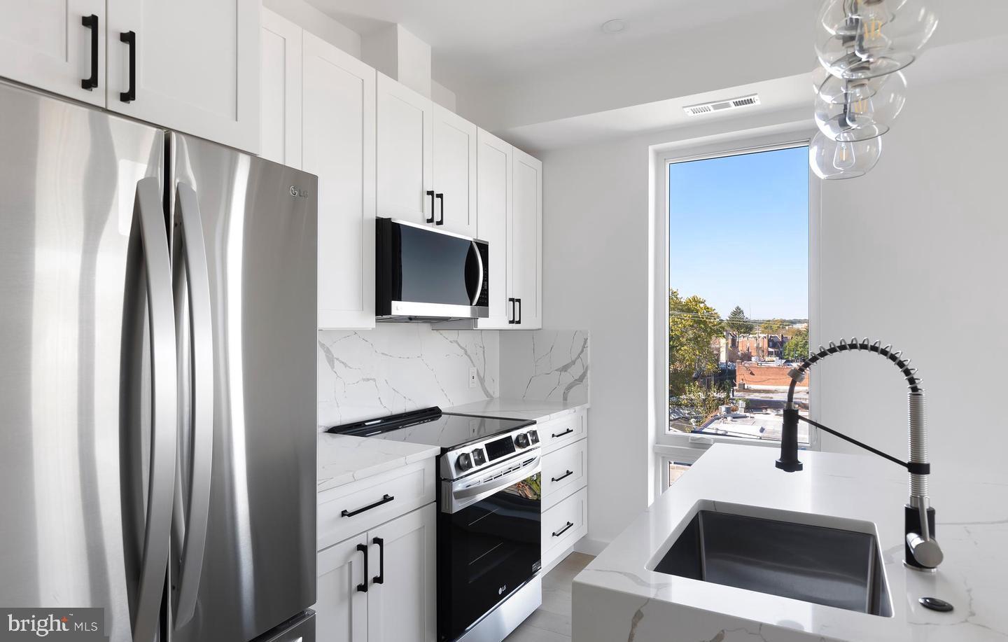 30 Kennedy Street Northwest, Unit 14 Washington, DC 20011 - Photo 8 of 40 a kitchen with stainless steel appliances a refrigerator sink and stove