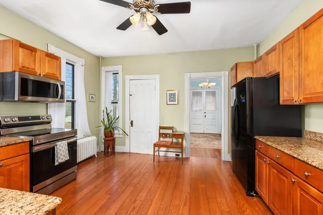 a kitchen with granite countertop stainless steel appliances a refrigerator a stove a sink a microwave oven and cabinets