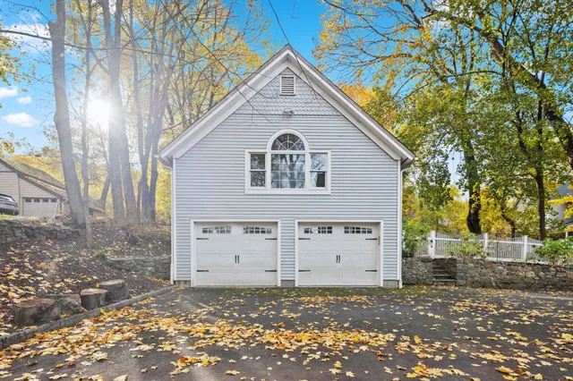 a big room with large trees and barn in the background