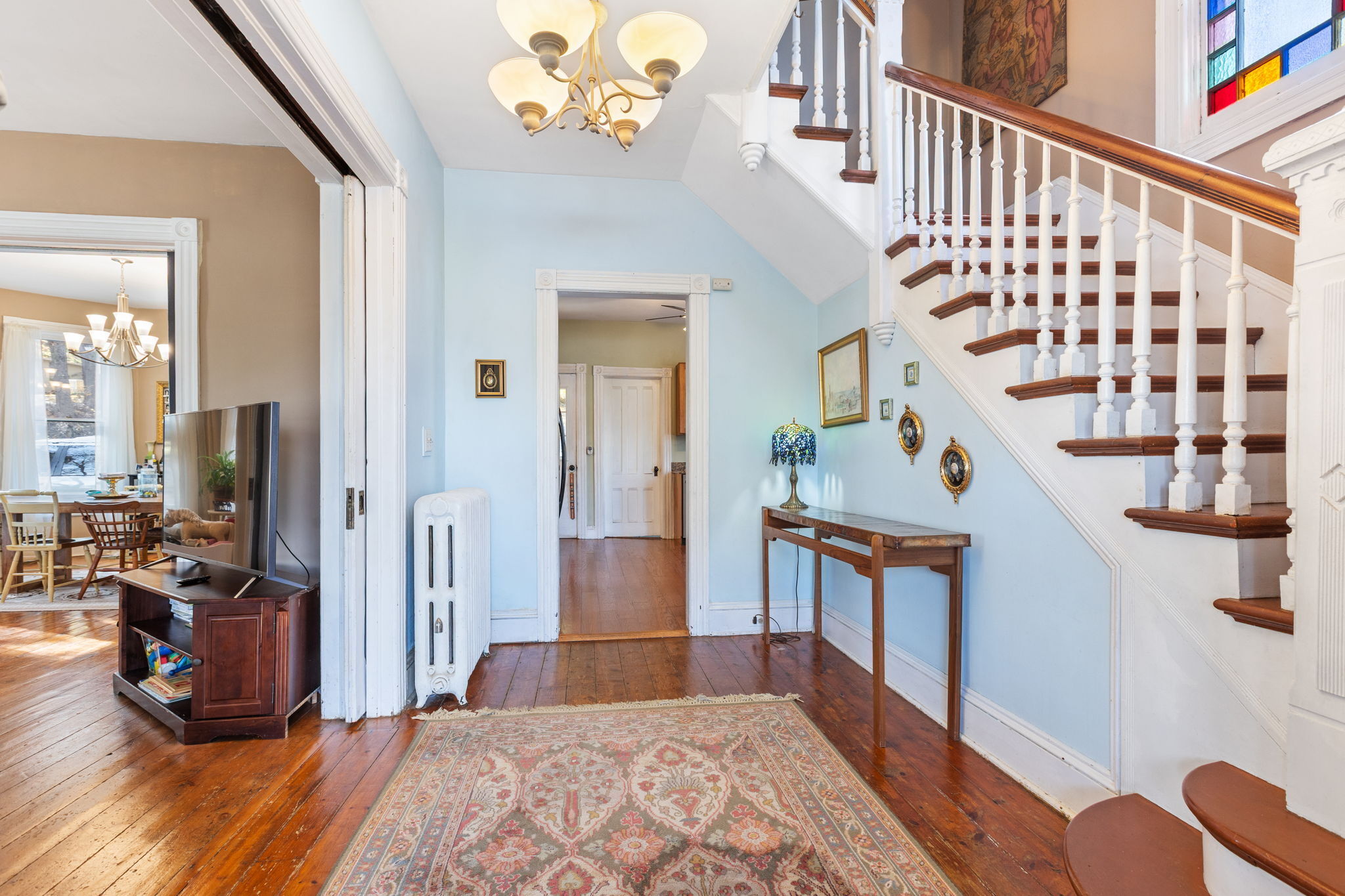 9 Mountainville Road Danbury, CT 06810 - Photo 5 of 36 a view of a hallway to a livingroom with wooden floor and furniture