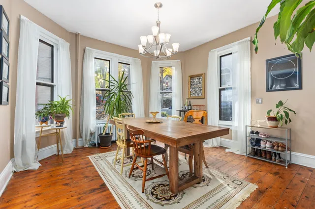 a living room with furniture a chandelier and a rug