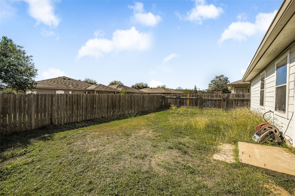 12517 Campana Drive Del Valle, TX 78617 - Photo 15 of 15 a view of a backyard with a table and chairs