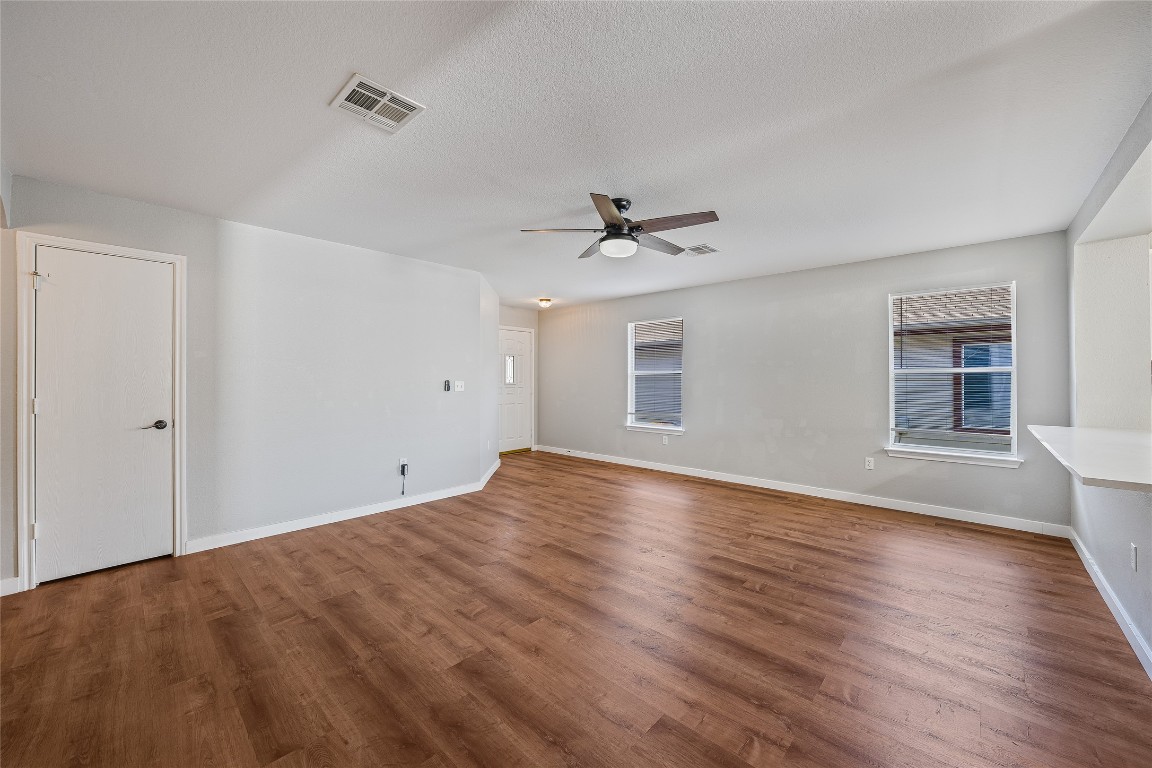12517 Campana Drive Del Valle, TX 78617 - Photo 3 of 15 a view of empty room with wooden floor and fan