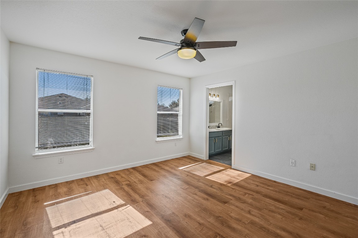 12517 Campana Drive Del Valle, TX 78617 - Photo 7 of 15 a view of an empty room with wooden floor and a window