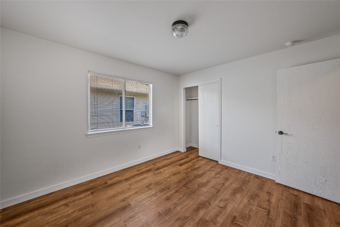 12517 Campana Drive Del Valle, TX 78617 - Photo 10 of 15 a view of empty room with wooden floor and fan