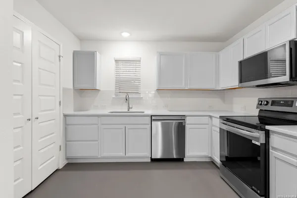 a view of a hallway with washer and dryer