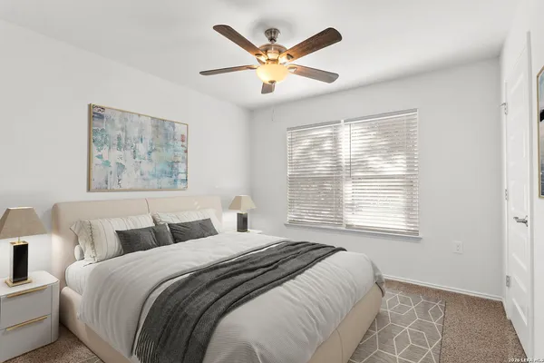 an empty room with window and ceiling fan