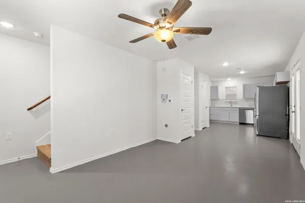 a view of an empty room with a ceiling fan