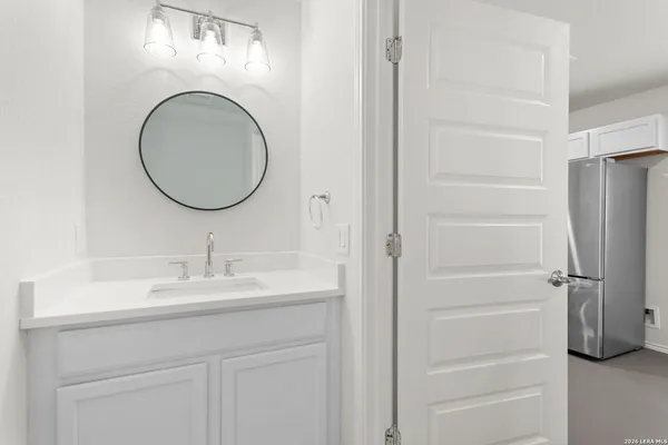 a kitchen with white cabinets and appliances