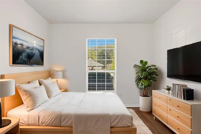 a bedroom with a bed and a flat screen tv