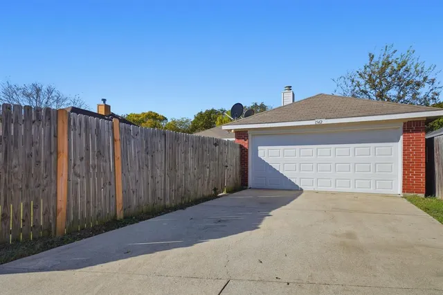 a view of backyard with a small cabin and wooden fence