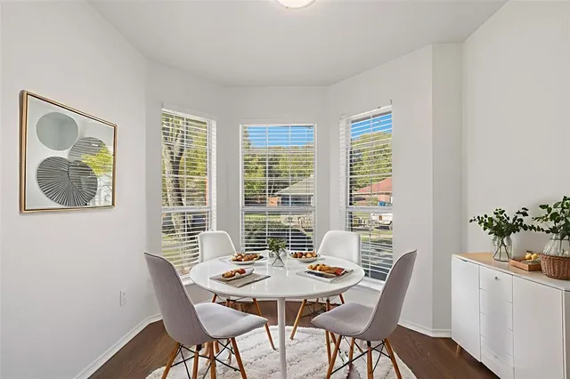 a view of a dining room with furniture and window