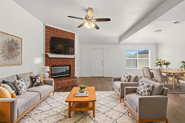 a living room with furniture a fireplace and a flat screen tv