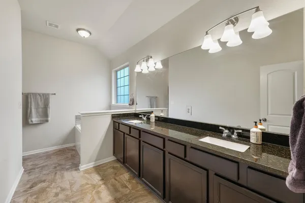 a view of a double sink and a mirror