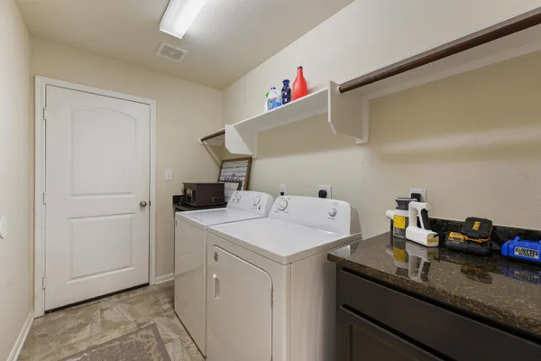 a utility room with sink dryer and washer