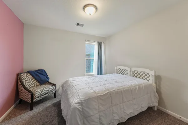 a bedroom with a bed and a couch