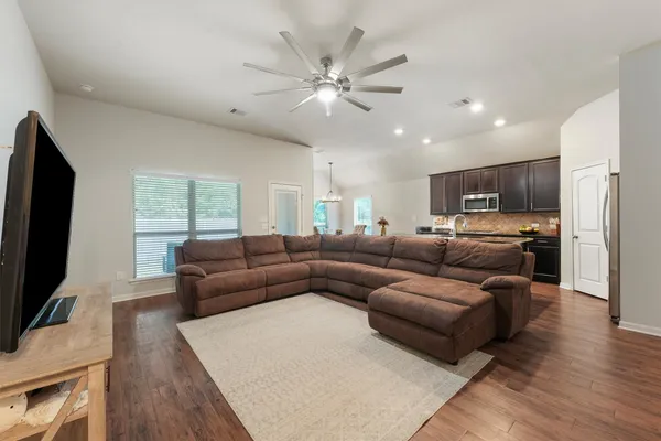 a living room with furniture and a flat screen tv