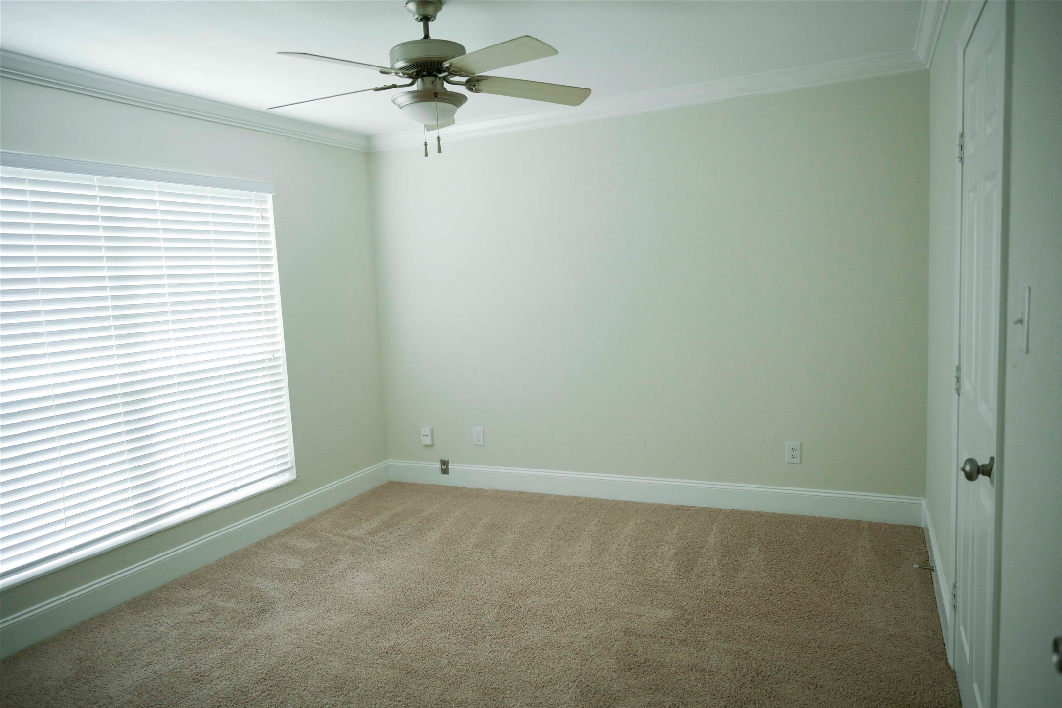 14209 Briarsage Court, Unit TH15 Houston, TX 77077 - Photo 11 of 31 an empty room with a window and a fan