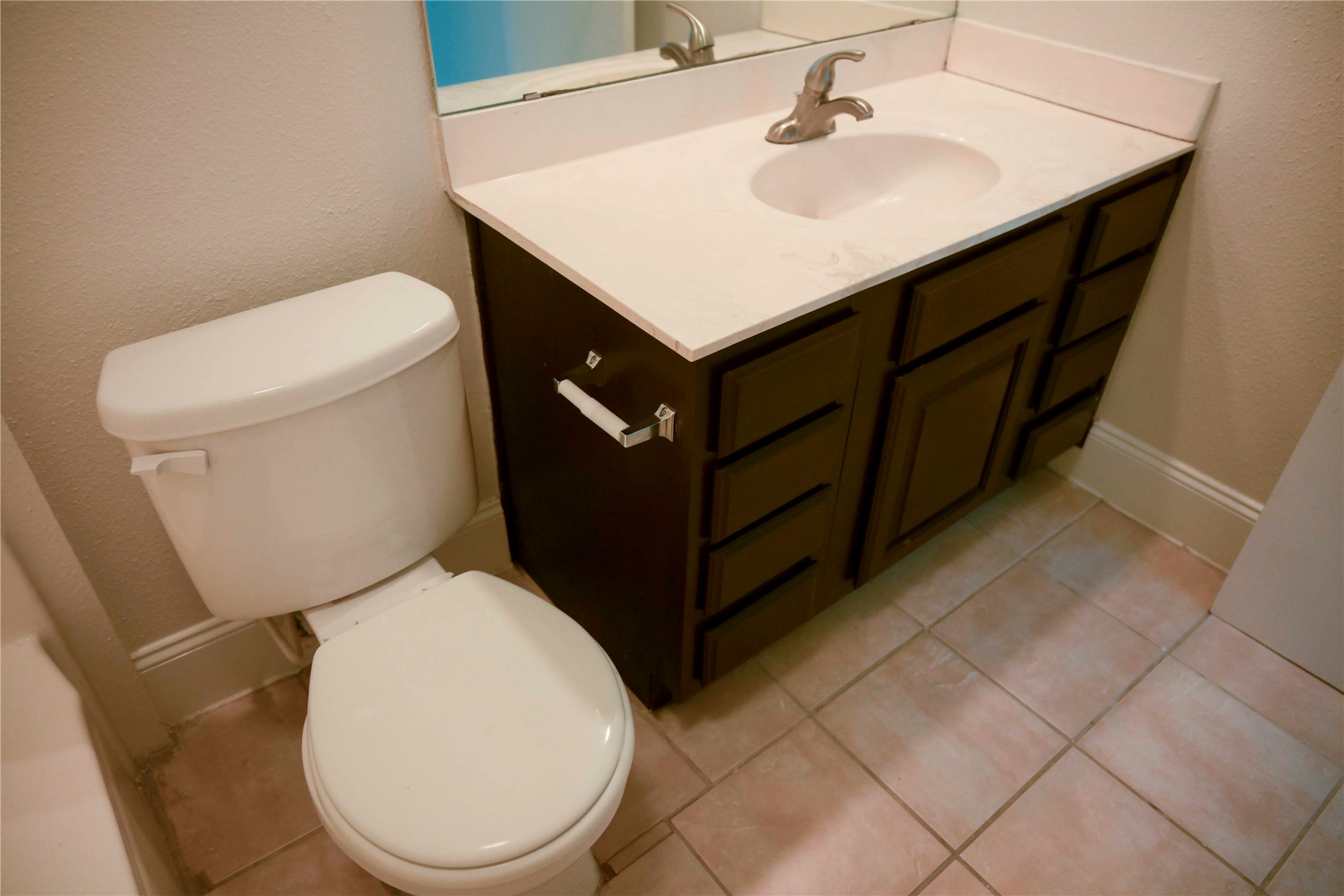 14209 Briarsage Court, Unit TH15 Houston, TX 77077 - Photo 18 of 31 a white toilet sitting next to a bathroom sink