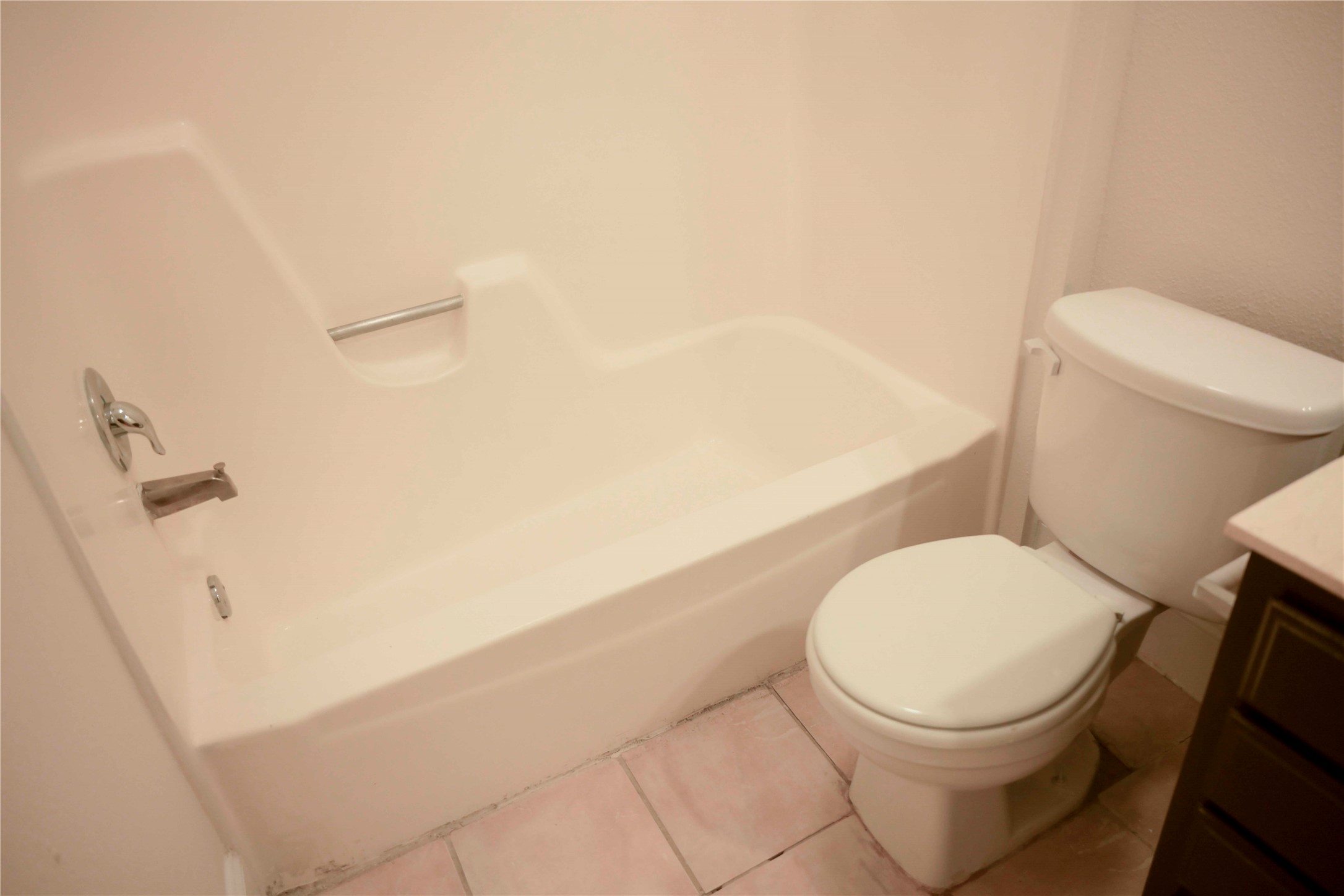 14209 Briarsage Court, Unit TH15 Houston, TX 77077 - Photo 22 of 31 a white toilet sitting next to a white sink and vanity