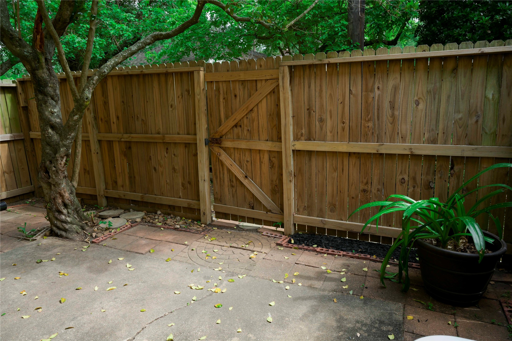 14209 Briarsage Court, Unit TH15 Houston, TX 77077 - Photo 26 of 31 a backyard of a house with chairs