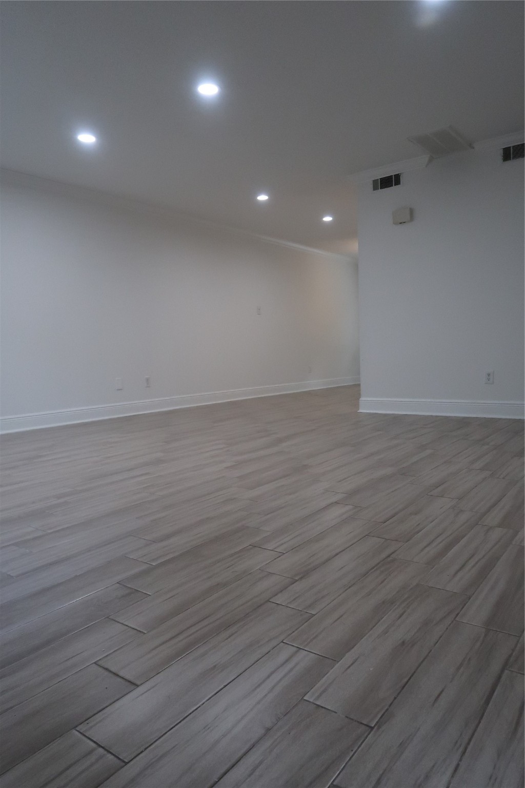 14209 Briarsage Court, Unit TH15 Houston, TX 77077 - Photo 5 of 31 an empty room with wooden floor and entrance