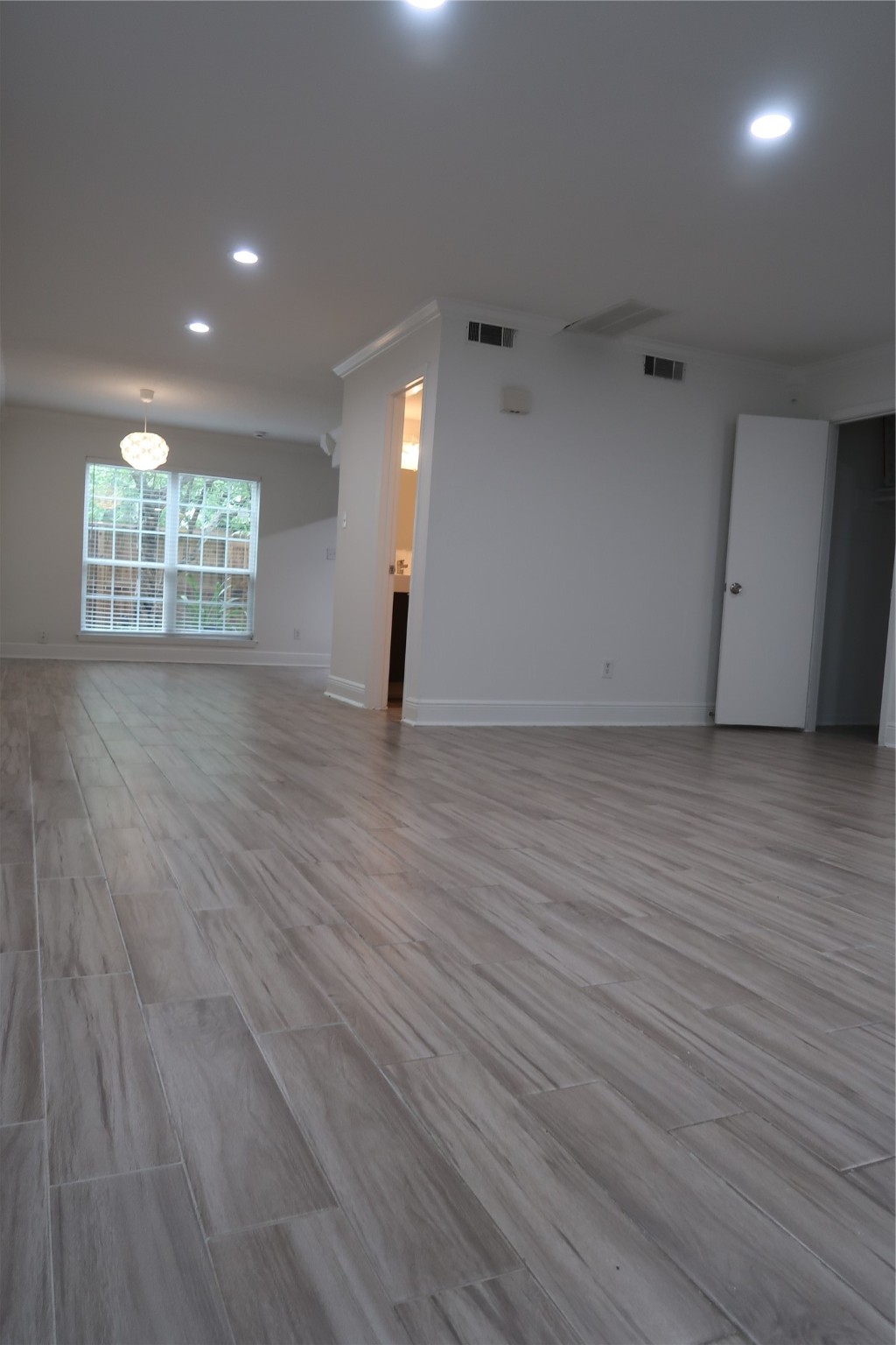 14209 Briarsage Court, Unit TH15 Houston, TX 77077 - Photo 6 of 31 an empty room with wooden floor and windows