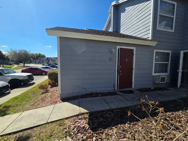 a couple of cars parked in front of a house