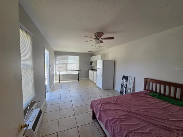 a bed room with a bed and a television