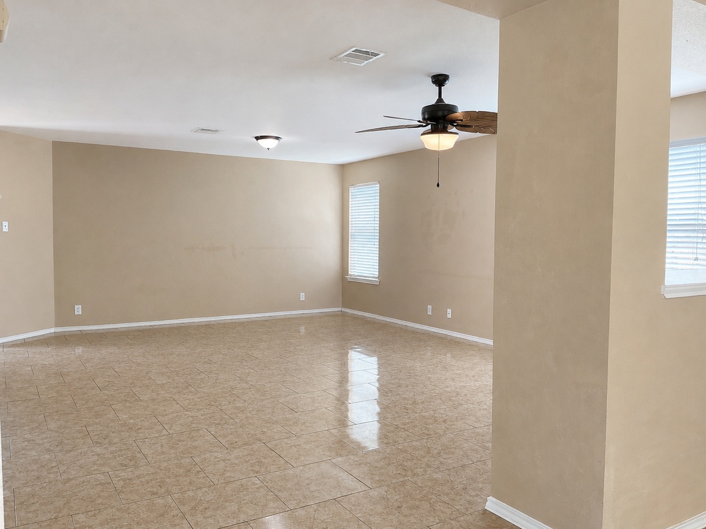 122 Rummel Drive Kyle, TX 78640 - Photo 6 of 18 A spacious living area features tiled flooring, an overhead light, and a ceiling fan for comfort.