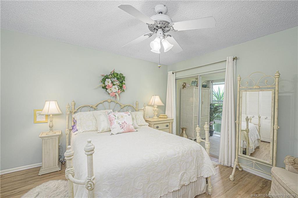 2929 Southeast Ocean Boulevard, Unit 1436 Stuart, FL 34996 - Photo 11 of 18 a bedroom with a bed and a chandelier